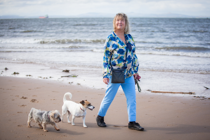 Gill walking her dog on the beach, photograph